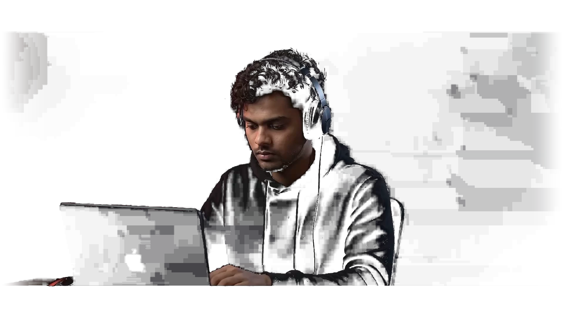 Jerald in a black hoodie working on a laptop